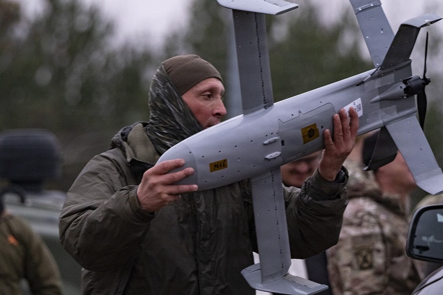 Polish soldier carries a Merops Surveyor interceptor to its launcher near Lipa, Poland, November 2025.